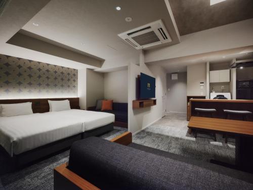a hotel room with a bed and a couch at MONday Apart Premium Asakusa in Tokyo