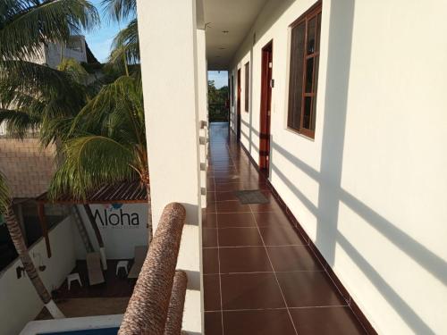 a hallway of a house with two wicker chairs at Casa aloha-Isla Holbox in Holbox Island