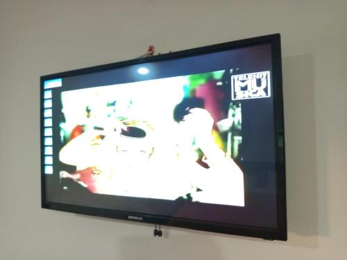 a flat screen tv hanging on a wall at Casa aloha-Isla Holbox in Holbox Island