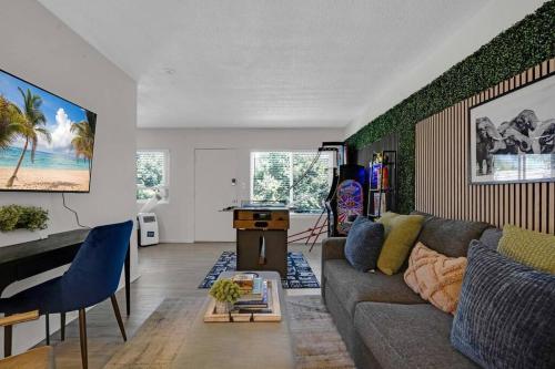 a living room with a couch and a table at 6th Haven, Arcade, King Bed, Games, 1 Mile to Beaches in Long Beach