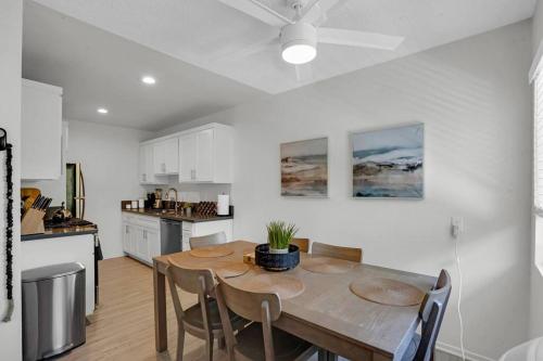 a kitchen and dining room with a table and chairs at 6th Haven, Arcade, King Bed, Games, 1 Mile to Beaches in Long Beach