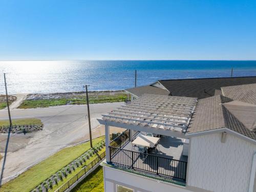a view of the ocean from the balcony of a house at Salty Breeze by Pristine Property Vacation Rentals in Saint Joe Beach