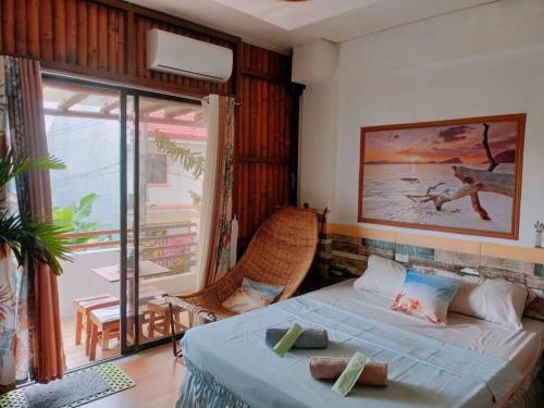 a bedroom with a bed and a view of the ocean at House of Bela in Iloilo City
