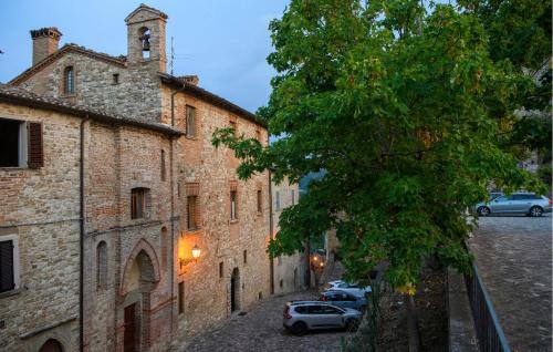 an alley with cars parked next to a building at Stunning Home In Macerata Feltria in Macerata Feltria