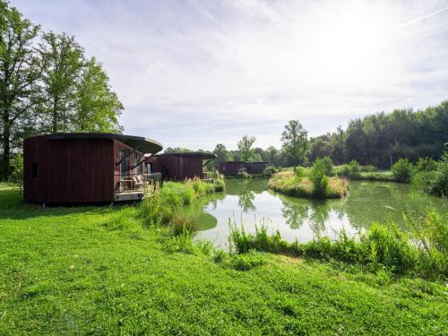 a group of houses on the side of a river at Nature Retreat in Antoing in Antoing