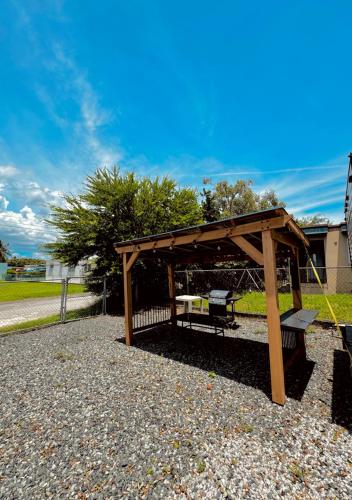 a wooden pavilion with a bench in a park at Costa Del Encanto Camper RV in Betances