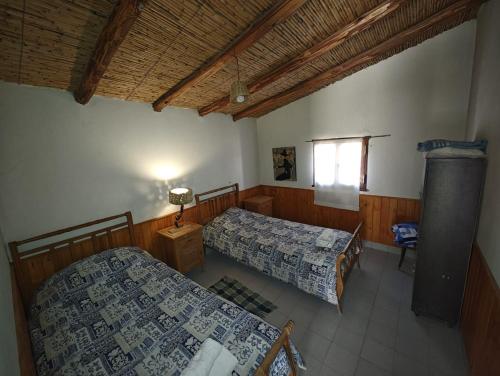 a room with two beds and a window at Cabañas El Molino in Senador Pérez