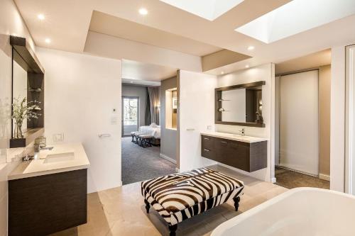 a bathroom with a zebraebra ottoman in front of a bath tub at Bayside Bliss in Dunsborough