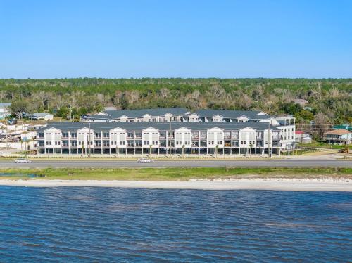 a large building on the beach next to the water at Pelican Crossing by Pristine Properties Vacation Rentals in Cape San Blas