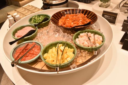 a display of different types of food on a table at Biei Shirogane Onsen Hotel Park Hills in Biei