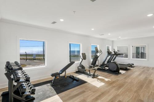 a gym with treadmills and elliptical machines at Beach View Upper by Pristine Properties Vacation Rentals in Mexico Beach