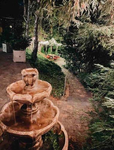 a stone fountain with a vase on top of it at Redwood Garden in Sacramento