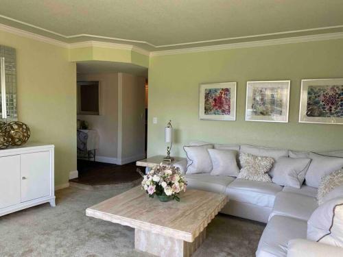 a living room with a white couch and a table at Redwood Garden in Sacramento
