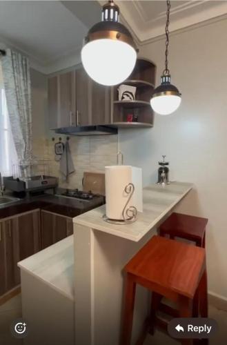 a kitchen with a table with a paper towel on it at Hillz furnished apartments in Nsasa