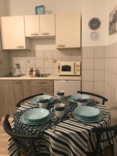 a kitchen with a table with plates on it at Gente di mare in Novi Vinodolski