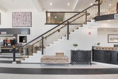 a living room with a staircase and a couch at Elkotel in Elko