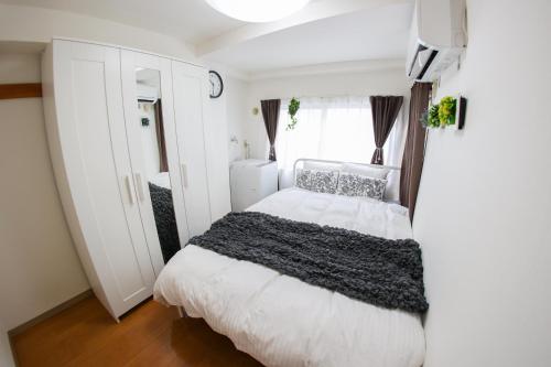 Ένα ή περισσότερα κρεβάτια σε δωμάτιο στο ハイクレスト中野201