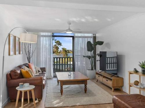 a living room with a couch and a coffee table at Young unit3 Lake Access in Nagambie