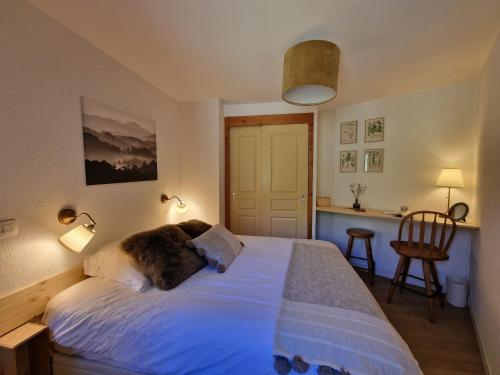 a bedroom with a bed with a dog on it at Appartement cosy 6 pers, au pied des pistes avec balcon et WiFi - FR-1-178-386 in Les Bruyères
