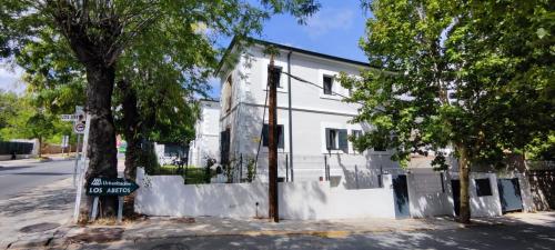 a white building with a no parking sign in front of it at La Casita de Lauri in Escorial
