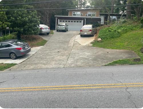 zwei Autos in einer Einfahrt mit einer Garage geparkt in der Unterkunft Embry Hills in Habersham