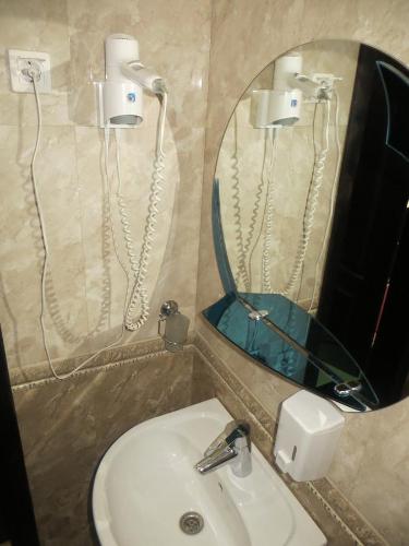 a bathroom with a sink and a mirror at 100 metriv vid vytyagu in Bukovel