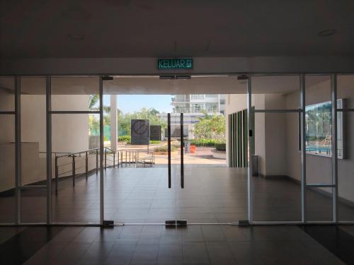 an open door to a building with a sign on it at J&K Guesthouse at Palmyra Residence in Kajang