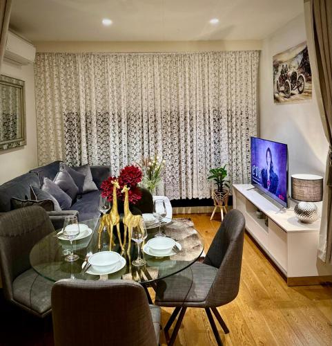 a living room with a couch and a table at Apartment 405 8 Daly St South Yarra 3141 LUCIA in Melbourne