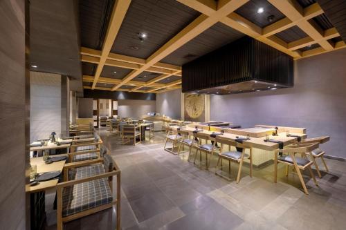 a dining room with wooden tables and chairs at Islamabad Marriott Hotel in Islamabad