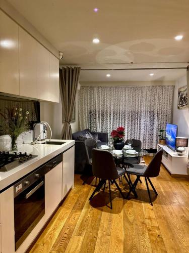 a kitchen and living room with a table and chairs at Apartment 405 8 Daly St South Yarra 3141 LUCIA in Melbourne