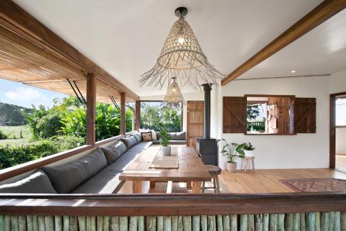 a living room with a couch and a table at Adora Villa in Ewingsdale