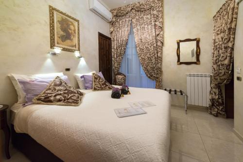 a bedroom with a large bed in a room at B&B Roma Royal Residence in Rome