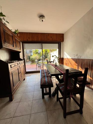a kitchen with a table and chairs and a large window at La Casa de los Abuelos in Gualeguaychú