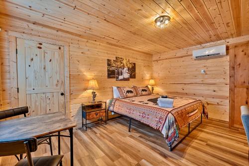 a bedroom with a bed in a wooden cabin at Retreat on the Lake in Hiawassee