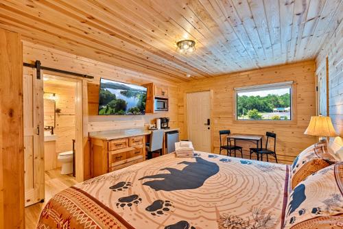 a bedroom with a bed in a wooden cabin at Retreat on the Lake in Hiawassee