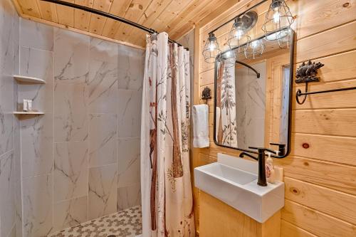 a bathroom with a shower and a sink at Retreat on the Lake in Hiawassee