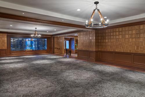 a large room with a large carpeted room with chandeliers at St. Regis Aspen Resort in Aspen