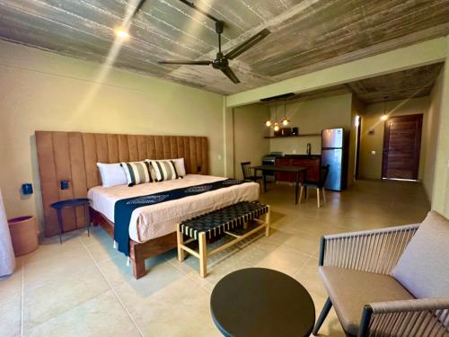 a bedroom with a bed and a table and chairs at Lolitas Suites 303 in Zihuatanejo