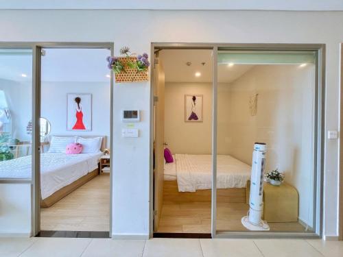 a room with a bed and a sliding glass door at PƠ Homestay THESONG Vũng Tàu in Vung Tau
