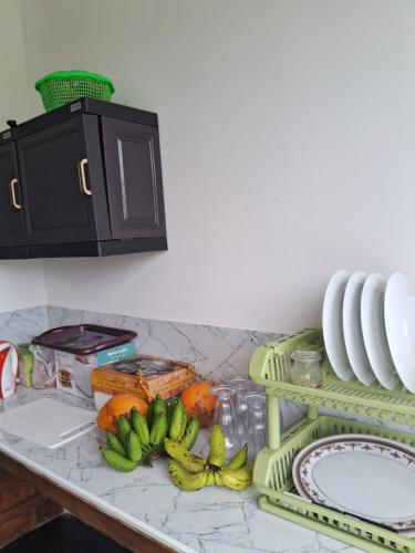 a kitchen counter with bananas and other fruits on it at RKO Villa27 - Unawatuna in Habaraduwa
