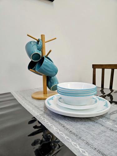 a table with a bowl and a bird statue on it at The Avani Seroja Hills in Sepang