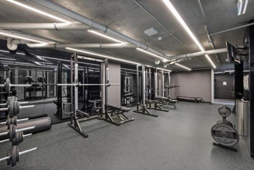 a gym with lots of equipment in a room at Modern, Executive 1 Bedroom Apartment With Balcony in Melbourne