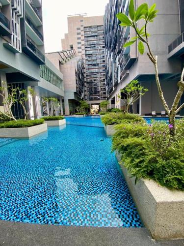 a swimming pool in the middle of a building at Imperio Residence by Savoír in Melaka