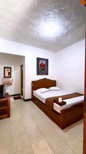 a bedroom with a bed and a ceiling at Rinjani Homestay in Pangandaran