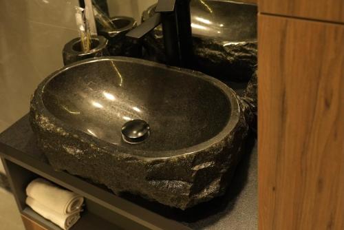 a bathroom sink with a granite counter top at SkySpa Apartments - апартаменти з джакузі на терасі з видом на Печерськ in Kyiv