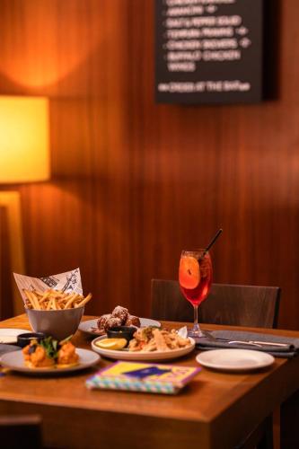 a table with two plates of food and a drink at Sydney Harbour Hotel in Sydney