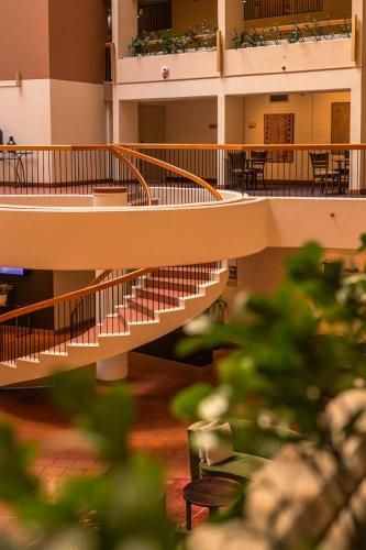 an empty building with stairs and tables and chairs at Sydney Harbour Hotel in Sydney