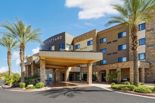 a rendering of the front of a hotel with palm trees at Courtyard by Marriott Phoenix Mesa Gateway Airport in Mesa