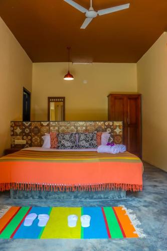 a bedroom with a large bed with a colorful bedspread at Beyond Eco Living in Munnar