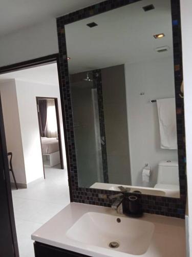 a bathroom with a sink and a large mirror at Large Corner Apartment 1BR - NV-207 in Ban Klang
